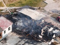 A hotel house is engulfed by fire in Xindian town, Tongren, China, on September 27, 2024. (