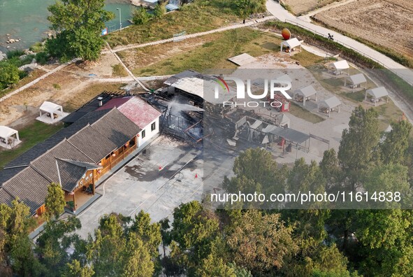 A hotel house is engulfed by fire in Xindian town, Tongren, China, on September 27, 2024. 