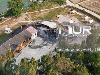 A hotel house is engulfed by fire in Xindian town, Tongren, China, on September 27, 2024. (