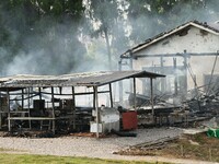 A hotel house is engulfed by fire in Xindian town, Tongren, China, on September 27, 2024. (