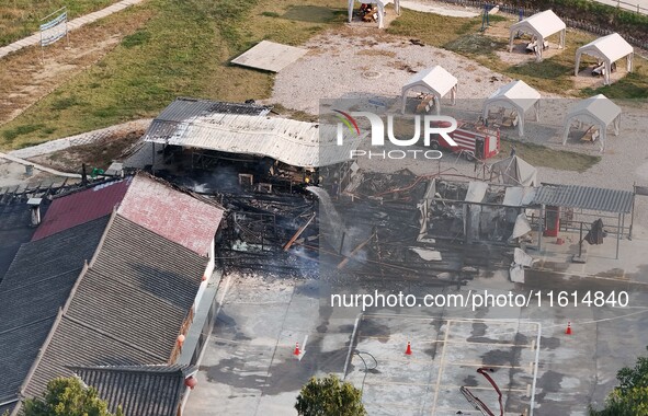 A hotel house is engulfed by fire in Xindian town, Tongren, China, on September 27, 2024. 