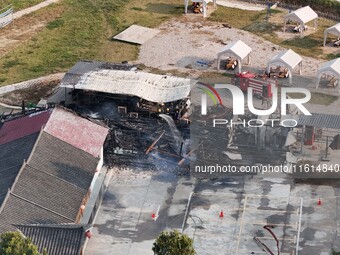 A hotel house is engulfed by fire in Xindian town, Tongren, China, on September 27, 2024. (