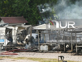 A hotel house is engulfed by fire in Xindian town, Tongren, China, on September 27, 2024. (