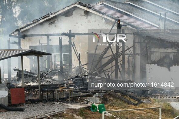 A hotel house is engulfed by fire in Xindian town, Tongren, China, on September 27, 2024. 