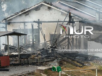 A hotel house is engulfed by fire in Xindian town, Tongren, China, on September 27, 2024. (