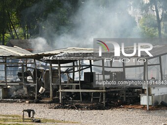 A hotel house is engulfed by fire in Xindian town, Tongren, China, on September 27, 2024. (