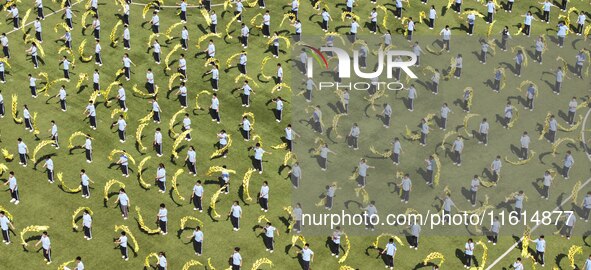 Students dance with a colored ribbon dragon at the No. 2 Middle School of Ecological Cultural Tourism District in Huai'an, China, on Septemb...