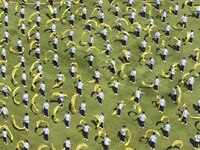 Students dance with a colored ribbon dragon at the No. 2 Middle School of Ecological Cultural Tourism District in Huai'an, China, on Septemb...