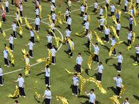 Students dance with a colored ribbon dragon at the No. 2 Middle School of Ecological Cultural Tourism District in Huai'an, China, on Septemb...