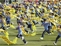 Students dance with a colored ribbon dragon at the No. 2 Middle School of Ecological Cultural Tourism District in Huai'an, China, on Septemb...