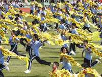 Students dance with a colored ribbon dragon at the No. 2 Middle School of Ecological Cultural Tourism District in Huai'an, China, on Septemb...