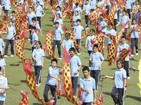 Students dance with a colored ribbon dragon at the No. 2 Middle School of Ecological Cultural Tourism District in Huai'an, China, on Septemb...