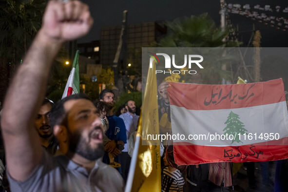 An Iranian protester shouts anti-Israeli and anti-U.S. slogans while taking part in a protest gathering to condemn an Israeli air strike aga...