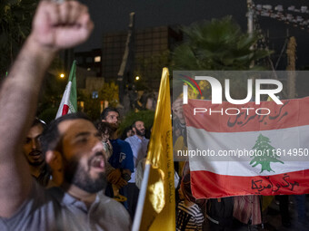 An Iranian protester shouts anti-Israeli and anti-U.S. slogans while taking part in a protest gathering to condemn an Israeli air strike aga...