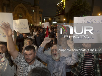 Iranian protesters shout anti-Israeli and anti-U.S. slogans while taking part in a protest gathering to condemn an Israeli air strike agains...