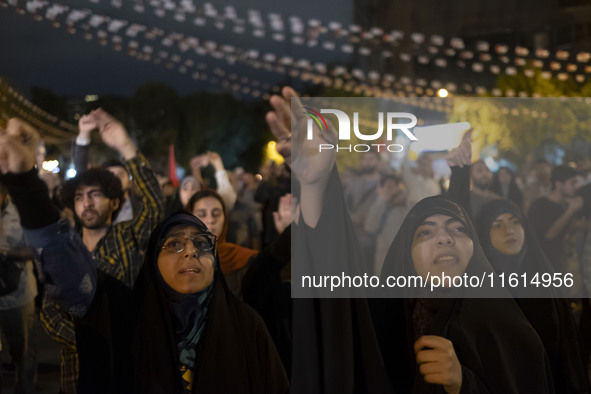 Veiled Iranian protesters shout anti-Israeli and anti-U.S. slogans while taking part in a protest gathering to condemn an Israeli air strike...