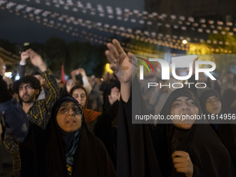 Veiled Iranian protesters shout anti-Israeli and anti-U.S. slogans while taking part in a protest gathering to condemn an Israeli air strike...