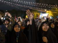 Veiled Iranian protesters shout anti-Israeli and anti-U.S. slogans while taking part in a protest gathering to condemn an Israeli air strike...