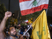 An Iranian protester waves a flag of Lebanon's Hezbollah while shouting anti-Israeli and anti-U.S. slogans during a protest gathering to con...