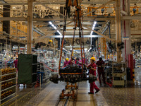 Workers work on a vehicle assembly line at a light truck workshop of Anhui Jianghuai Automobile Group Co LTD in Hefei, China, on September 2...