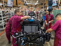 Workers work on a vehicle assembly line at a light truck workshop of Anhui Jianghuai Automobile Group Co LTD in Hefei, China, on September 2...