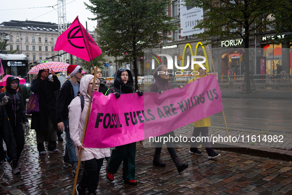 Activists from the environmental group Extinction Rebellion Finland ''Elokapina'' protest in Helsinki, Finland, on September 27, 2024. The g...