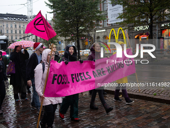 Activists from the environmental group Extinction Rebellion Finland ''Elokapina'' protest in Helsinki, Finland, on September 27, 2024. The g...