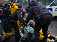 Activists from the environmental group Extinction Rebellion Finland ''Elokapina'' are arrested by the police during a protest in front of th...