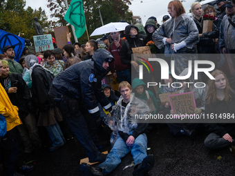 Activists from the environmental group Extinction Rebellion Finland ''Elokapina'' are arrested by the police during a protest in front of th...