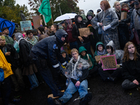 Activists from the environmental group Extinction Rebellion Finland ''Elokapina'' are arrested by the police during a protest in front of th...