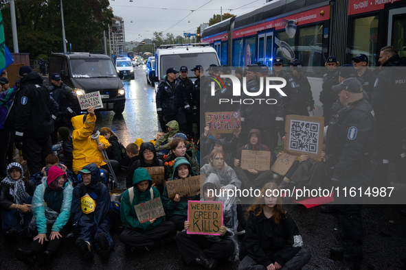 Activists from the environmental group Extinction Rebellion Finland ''Elokapina'' are surrounded by police during a protest in front of the...