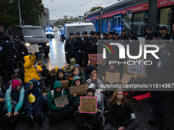 Activists from the environmental group Extinction Rebellion Finland ''Elokapina'' are surrounded by police during a protest in front of the...