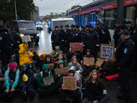 Activists from the environmental group Extinction Rebellion Finland ''Elokapina'' are surrounded by police during a protest in front of the...