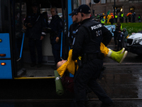 An activist from the environmental group Extinction Rebellion Finland ''Elokapina'' is arrested by the police during a protest in front of t...