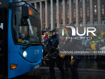 An activist from the environmental group Extinction Rebellion Finland ''Elokapina'' is arrested by the police during a protest in front of t...