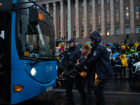 An activist from the environmental group Extinction Rebellion Finland ''Elokapina'' is arrested by the police during a protest in front of t...