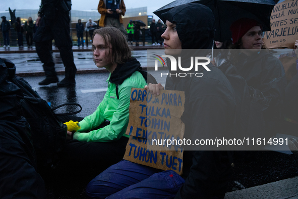 Activists from the environmental group Extinction Rebellion Finland ''Elokapina'' protest in front of the Finnish Parliament in Helsinki, Fi...