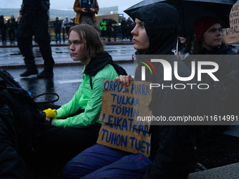 Activists from the environmental group Extinction Rebellion Finland ''Elokapina'' protest in front of the Finnish Parliament in Helsinki, Fi...