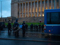 An activist from the environmental group Extinction Rebellion Finland ''Elokapina'' is arrested by the police during a protest in front of t...