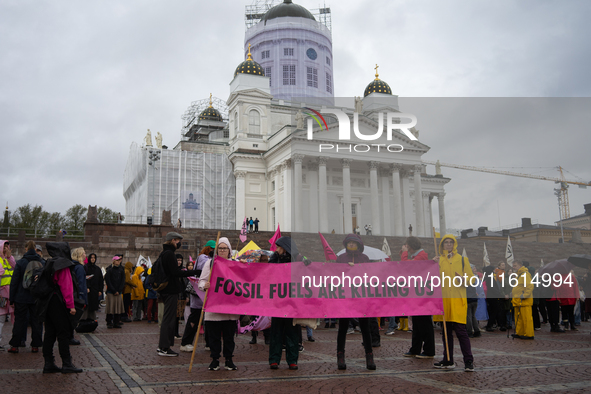 Activists from the environmental group Extinction Rebellion Finland ''Elokapina'' protest in Helsinki, Finland, on September 27, 2024. The g...