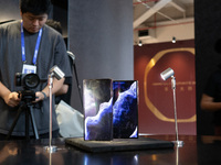 Customers experience a triple foldable phone at the Huawei exhibition area at WDCC2024 in Shanghai, China, on September 27, 2024. (