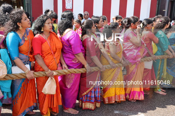 Women pull the chariot as Tamil Hindu devotees take part in the chariot procession (ther) during the Ganesha Mahotshava Vingnapanam Festival...