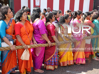 Women pull the chariot as Tamil Hindu devotees take part in the chariot procession (ther) during the Ganesha Mahotshava Vingnapanam Festival...