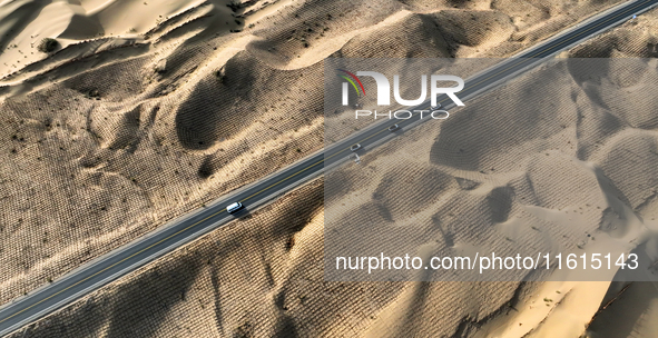 Vehicles drive on a desert highway in Bazhou, Xinjiang province, China, on September 23, 2024. 