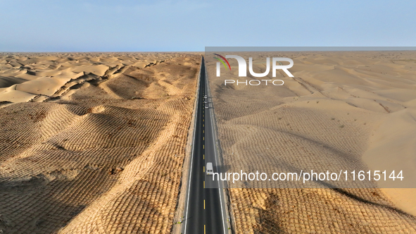 Vehicles drive on a desert highway in Bazhou, Xinjiang province, China, on September 23, 2024. 