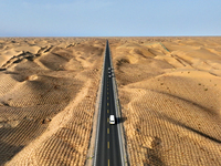 Vehicles drive on a desert highway in Bazhou, Xinjiang province, China, on September 23, 2024. (