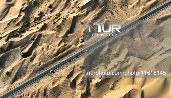 Vehicles drive on a desert highway in Bazhou, Xinjiang province, China, on September 23, 2024. 