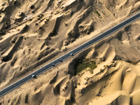 Vehicles drive on a desert highway in Bazhou, Xinjiang province, China, on September 23, 2024. (