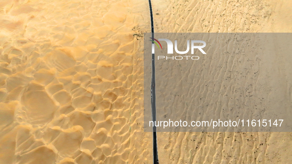 Vehicles drive on a desert highway in Bazhou, Xinjiang province, China, on September 23, 2024. 