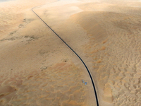 Vehicles drive on a desert highway in Bazhou, Xinjiang province, China, on September 23, 2024. (